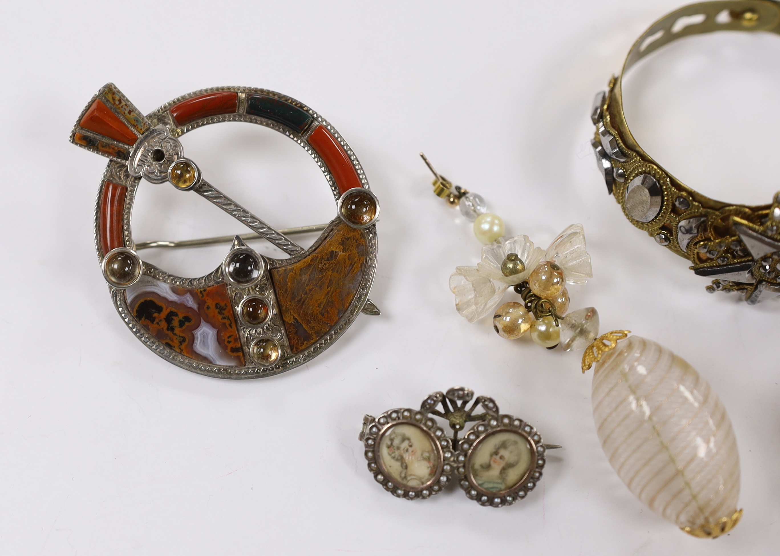 A small collection of assorted jewellery including a lava brooch, Scottish hardstone and cabochon set white metal brooch, pair of Venetian? glass drop earrings, two tone cut steel bangle and a white metal and simulated s